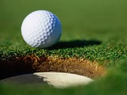 Golf Ball on edge of hole Golf Ball on edge of hole